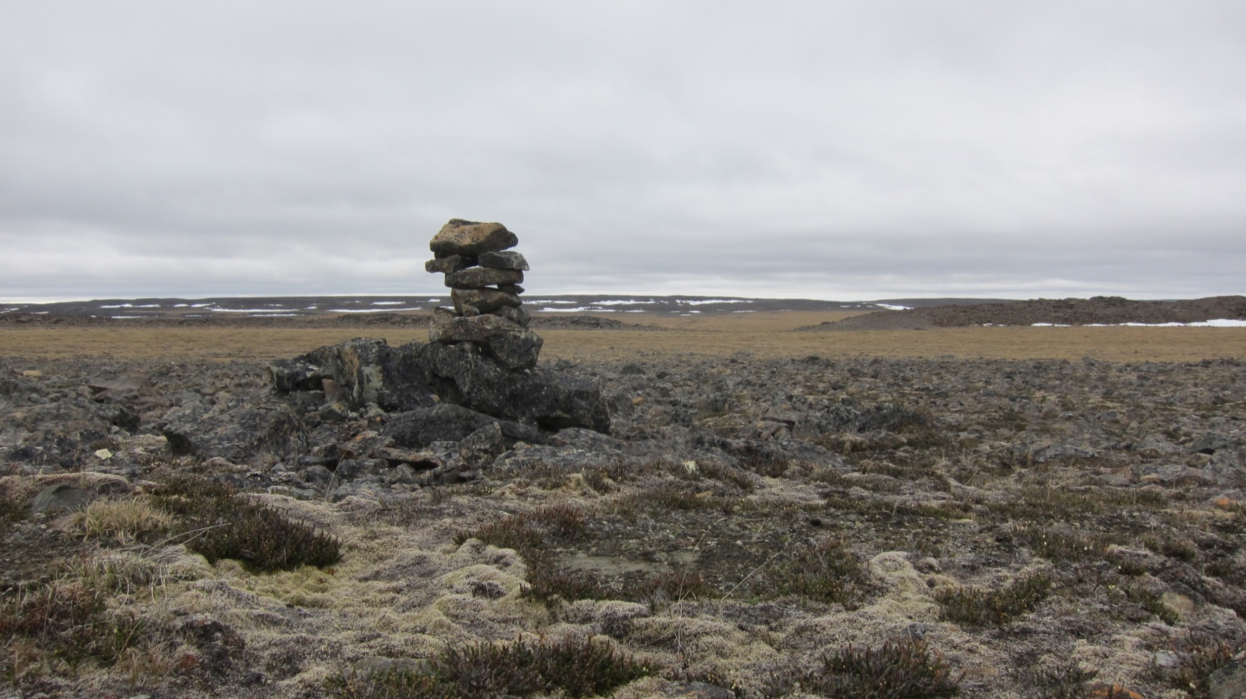 A traditional stone inuksuk in the landscape of Nunavik, Quebec